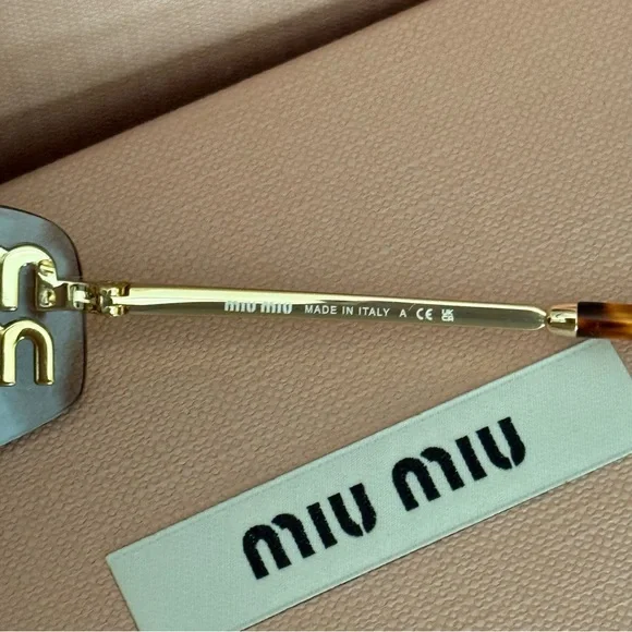Miu Miu Gold Sunglasses with Pink Velvet Case is available 
